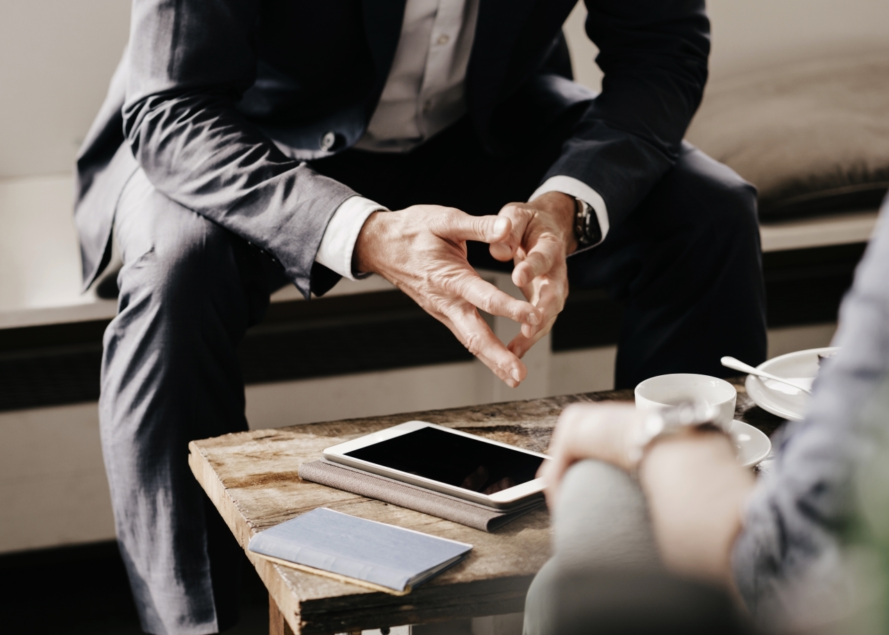 Advisor's hands as he meets with client